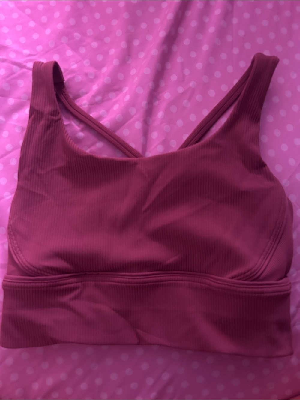 pink ribbed lululemon sports bra with criss-cross straps